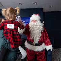 Girl high fives Santa